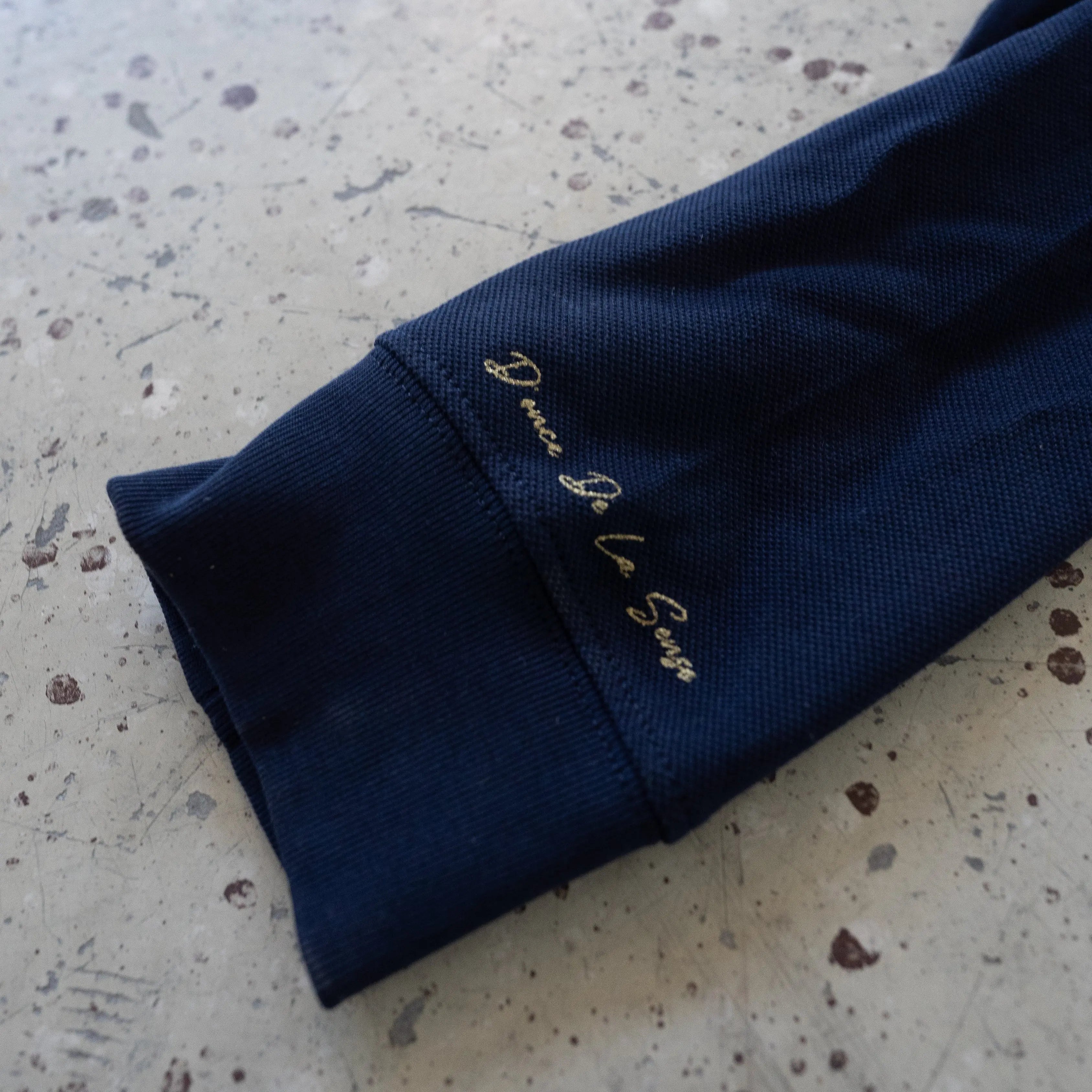 Donce de la Sense Polo Long Sleeve, featuring a meticulously finished front placket and handprinted details on the necktag and sleeve.
