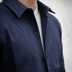 Navy blue jacket worn by a person with a neutral background